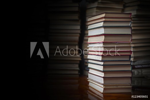 Picture of Stack of books against the background of a number of books a place for an inscription